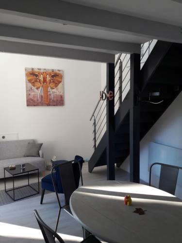 a living room with a couch and a surfboard on a table at Taillefer in Saint Paul de Loubressac