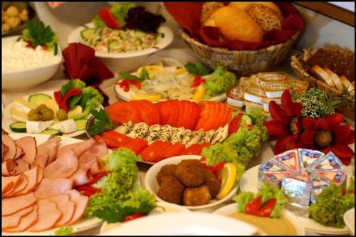 a bunch of different types of food on a table at Hotel Zaodrze in Opole