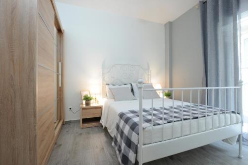 a bedroom with a white bed and a window at F & B Collection - close to Aristotelous sQ. in Thessaloniki