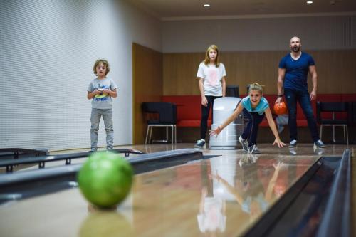 a group of people playing a game of bowling at Hotel S-PORT Véska in Dolany
