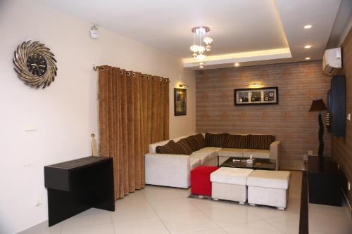 a living room with a couch and a table at Safari Club 4 in Rawalpindi