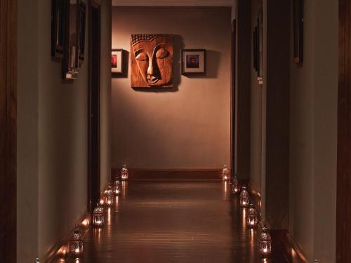 a hallway with lights and a mask on the wall at Macdonald Inchyra Hotel & Spa in Falkirk
