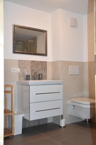 a bathroom with a white sink and a toilet at Ferienwohnung Veste Heldburg in Bad Rodach