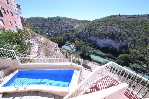 a swimming pool with a view of a mountain at Casa rural Vistas al Rio in Jorquera