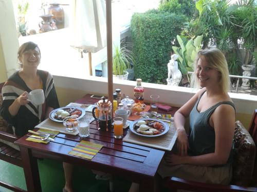 two women sitting at a table eating breakfast at Stadium Guest House in Cape Town