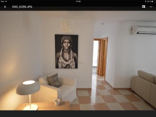 a living room with a couch and a picture on the wall at Calle Cinteria in Málaga