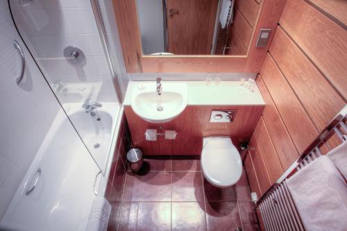 a small bathroom with a sink and a toilet at Strangford Arms Hotel in Newtownards