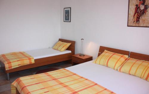 a bedroom with two beds and a lamp in it at Budget Apartments Batkoski Pag in Pag
