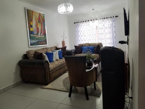 a living room with a couch and a table at Ave. Duarte k3/12, Residencial Palma Real, Santiago, RD in Arenoso