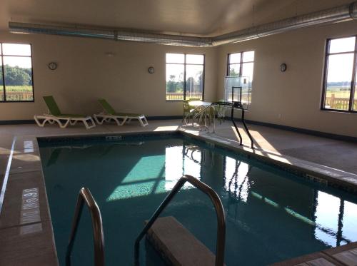 a large swimming pool in a large room with windows at Scenic Shore Inn in Algoma