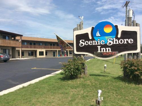 a sign for a cosmetic store in a parking lot at Scenic Shore Inn in Algoma