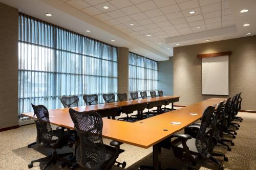 a conference room with long tables and chairs and a whiteboard at Harrah's Joliet, A Caesars Destination in Joliet