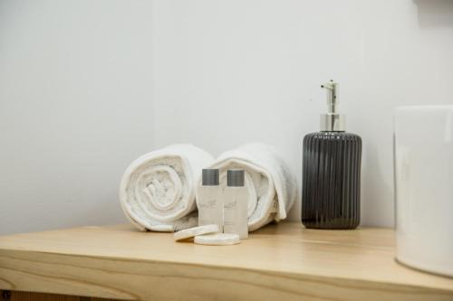 a shelf with towels and a heater on it at MiddleHouse in Braşov