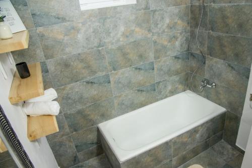a bathroom with a shower with a bench in it at MiddleHouse in Braşov