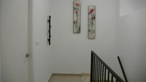 a staircase with two pictures on a white wall at Apartamento Portalet 7 in Benaguacil