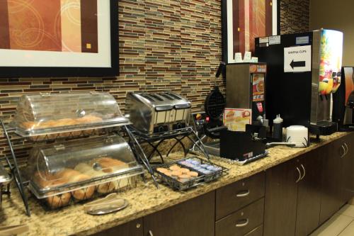 a counter with a bunch of donuts on it at Microtel Inn and Suites North Canton in North Canton
