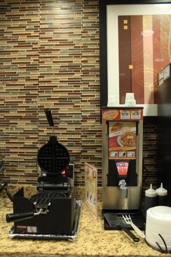 a krispy kreme machine with a laptop on a counter at Microtel Inn and Suites North Canton in North Canton