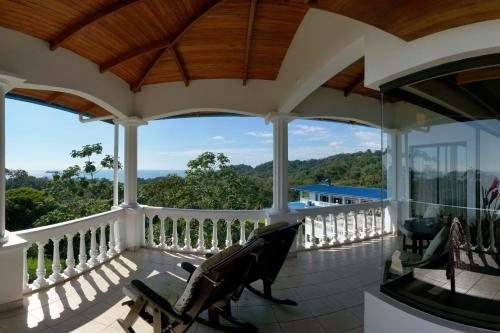 a screened in porch with a bench on it at Cristal Ballena Boutique Hotel & Spa in Uvita