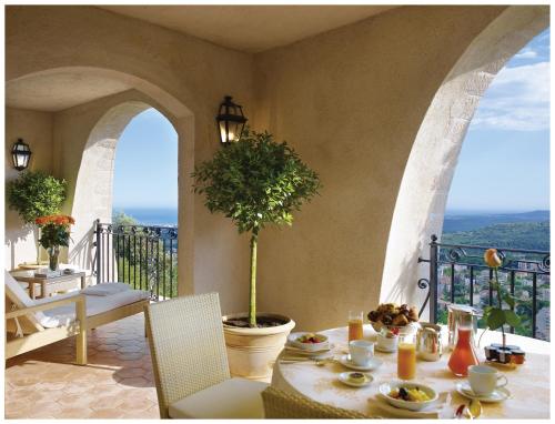 a table with a plant sitting on a balcony at Château Saint-Martin & Spa, Oetker Hotels in Vence