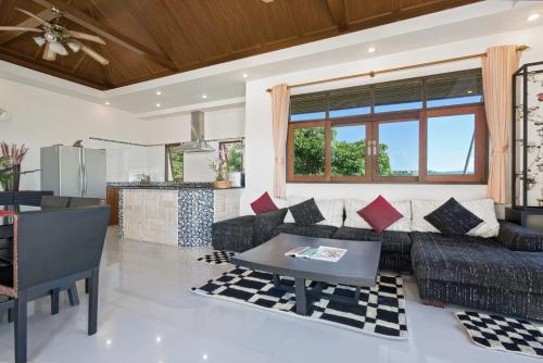 a living room with a couch and a table at Villa Liu in Nathon