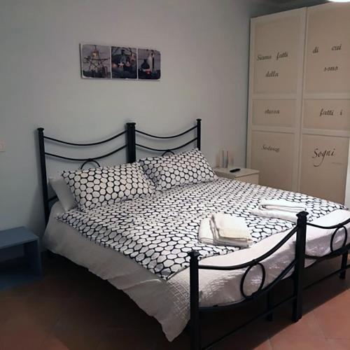 a bedroom with a bed with a black frame at Buellis House in Fregene