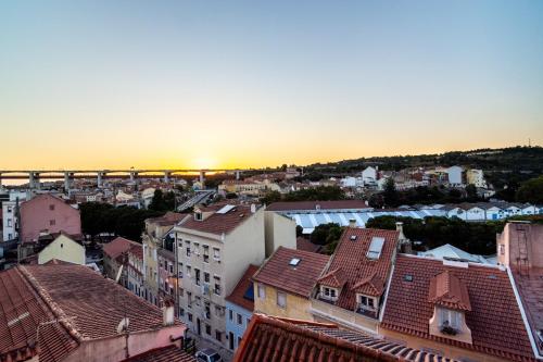 a view of a city with a bridge in the background at The Explorer's Home | Sunny. Central. Free Parking in Lisbon