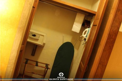 a green surfboard in a room with a door at Hotel Quinta Santiago in Querétaro