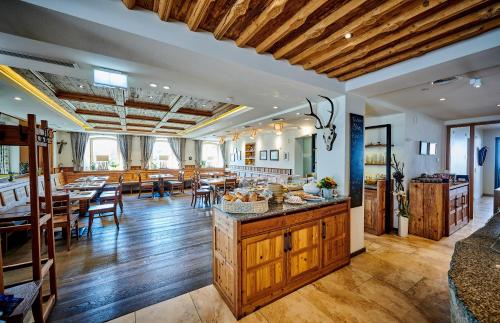 a kitchen and dining room with tables and chairs at Landgasthof Wurm in Bogen