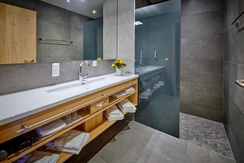 a bathroom with a sink and a mirror at Landgasthof Wurm in Bogen