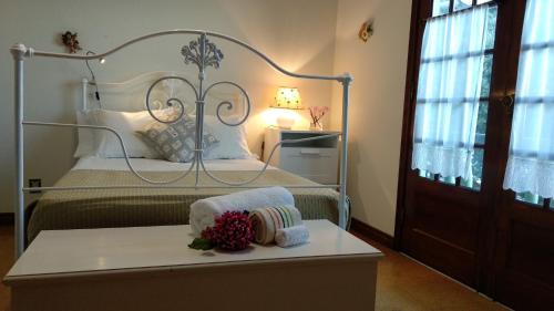 a bedroom with a bed and a table with towels at Green House - AL in Porto Formoso