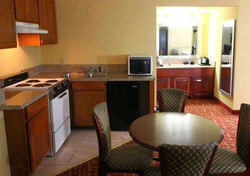 a kitchen with a table and a kitchen with a stove at Baymont by Wyndham Sevierville Pigeon Forge in Sevierville