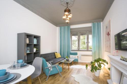 a living room with a couch and a table at Flamingos Apartment ★ Free Parking ★ City Center ★ in Novi Sad