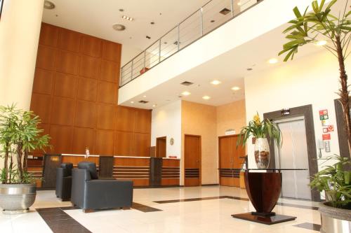 a lobby of a hospital with potted plants at Travel Inn Hotels Ibirapuera in Sao Paulo