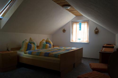 a bedroom with a bed and a window at Ferienhaus Fischer in Kurort Gohrisch