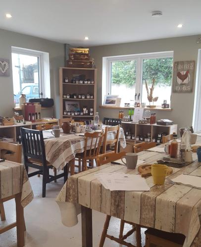 a room with wooden tables and chairs and windows at Gormanstown House Apt, The Island in Tullamore