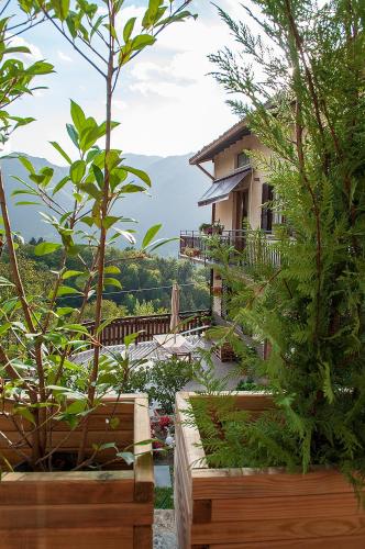 a house in the middle of a garden with trees at Bed &Breakfast Bellavista in San Giovanni Bianco