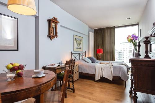 a bedroom with a bed and a table and a dining room at Apartament Triton Park in Warsaw