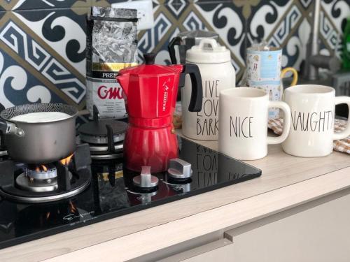 a shelf with coffee cups and a blender on it at Carmeloria II in Rincon