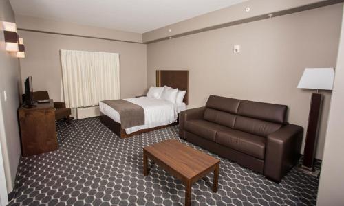 a hotel room with a bed and a couch at The Souris Hotel in Souris