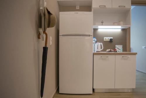 a refrigerator with an umbrella next to a kitchen at Chic and Minimal apartment close to Thissio Metro in Athens