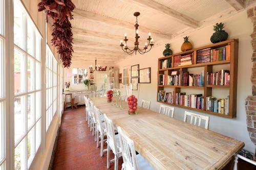 a long dining room with a long table and chairs at Casa Culinaria - The Gourmet Inn in Santa Fe