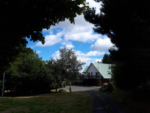 a house on the side of a road with trees at Robin's Nest B&B in Wilmot