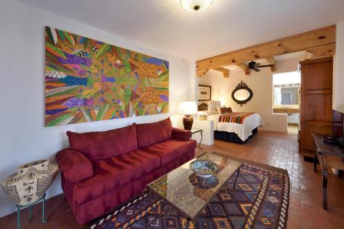 a living room with a couch and a bedroom at Casa Culinaria - The Gourmet Inn in Santa Fe