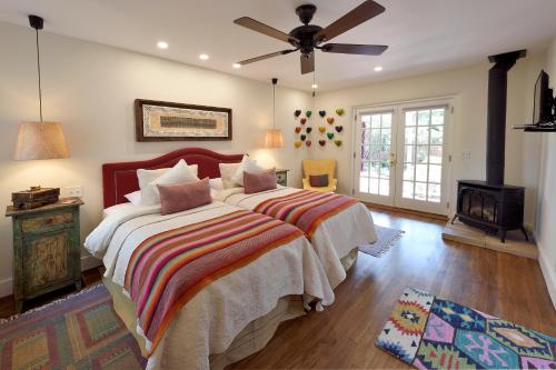 a bedroom with two beds and a ceiling fan at Casa Culinaria - The Gourmet Inn in Santa Fe