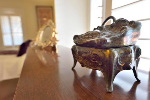 a metal bowl sitting on top of a wooden table at Casa Culinaria - The Gourmet Inn in Santa Fe