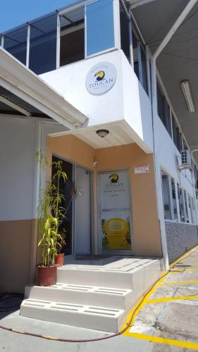 a building with stairs leading to the front door at Toucan Hostel in Alajuela City