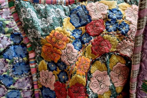 a close up of a quilt with flowers on it at Casa Culinaria - The Gourmet Inn in Santa Fe