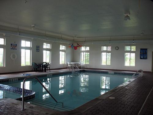 a large swimming pool in a building at Pellston Lodge in Pellston
