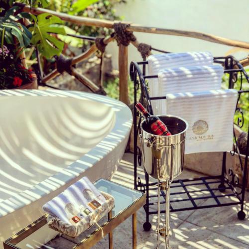 a table with a bucket of wine and a basket of towels at Casa Miura Hotel Boutique in Ajijic