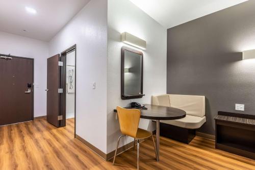 a small room with a table and a chair at Motel 6-Las Vegas, NV - Motor Speedway in Las Vegas